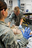 Tech. Sgt. Courtney Leahy watches as Airman 1st Class Joshua May practices using a defibrillator on a mock patient, May 9, 2013, at the 379th Air Expeditionary Wing’s medical facility. Leahy and May are 379th Expeditionary Medical Operations Squadron medical technicians and are deployed here from Joint Base Langley-Eustis, Va. The Air Force Medical Service celebrates Nurse and Medical Technician week May 6 - 12. (U.S. Air Force photo/Senior Airman Benjamin Stratton)