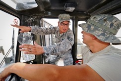 Staff Sgt. Roque Solis explains the finer operations of his favorite piece of equipment, the 50K Rough Terrain Container Handler, to Senior Airman Carlos Cassano at the 379th Air Expeditionary Wing in Southwest Asia, May 14, 2013. Solis and Cassano are 379th Expeditionary Logistics Readiness Squadron vehicle operators. Solis deployed from Fairchild Air Force Base, Wash., and Cassano from Luke AFB, Ariz. (U.S. Air Force photo/Senior Airman Benjamin Stratton)