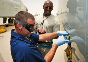 Staff Sgts. Tyler Wyatt and Wendell Parks service the engine oil during post-flight maintenance for a recently arrived RC-135 Rivet Joint May 22, 2013, at the 379th Air Expeditionary Wing in Southwest Asia. Wyatt and Parks are 763rd Aircraft Maintenance Unit jet engine mechanics deployed from Offutt Air Force Base, Neb. (U.S. Air Force photo/Senior Airman Benjamin Stratton)