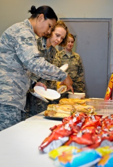 Senior Airman Vikki Flores and Lt. Col. Sirena Morris select which sandwich to eat during the Womens Equality Day celebration at the 379th Air Expeditionary Wing in Southwest Asia, Aug. 26, 2013. Flores is a 379th Expeditionary Civil Engineer Squadron emergency management journeyman deployed from Dover Air Force Base, Del., and an Azusa, Calif., native. Morris is the 379th Expeditionary Force Support Squadron commander and a Fayetteville, N.C., native. (U.S. Air Force photo/Senior Airman Benjamin Stratton)